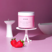 amaraa Blush Berry Polish whipped scrub jar on white stand with strawberries, pink background